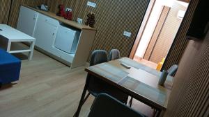 a room with a table and chairs and a tv at YES! Rooms in Alicante