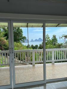a view of the ocean from the balcony of a house at The Sunset Suite Panoramic Sea Views in Sikao +4 photos