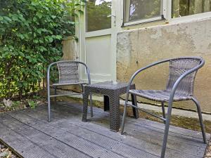 two chairs and a table on a porch at Konstanzer 3 - Spacious 2-Room Apt - Iulius Mall in Iaşi