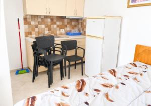a kitchen with chairs and a table and a refrigerator at Wonderful Sea View in Borsh +5 photos