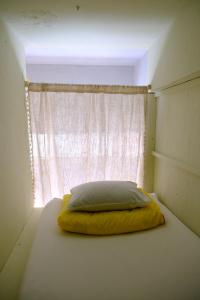 a bed in a room with a window at The hostel kobe in Kobe