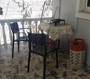 a table and chairs in a room with a window at Wonderful Sea View in Borsh