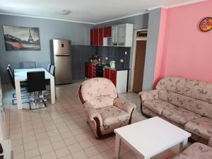 a living room with a couch and a table and a kitchen at Zorica in Rafailovici