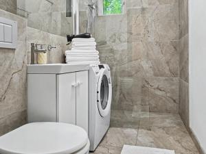 a bathroom with a washing machine and a toilet at Konstanzer 3 - Spacious 2-Room Apt - Iulius Mall in Iaşi