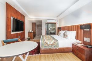 a hotel room with a bed and a table at Hotel 11 Boulevard - Dal Lake View in Srinagar