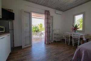 a room with a kitchen and a dining room with a table at Residence Limoneto Ischia in Forio d'Ischia