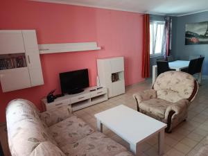 a living room with a couch and a tv at Zorica in Rafailovici