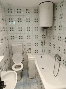 a bathroom with a toilet and a tub and a sink at Zorica in Rafailovici +13 photos