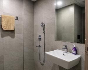 a bathroom with a shower and a sink and a mirror at TOM n JERY STAYS in Greater Noida