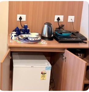 a cabinet with a counter top with a table at TOM n JERY STAYS in Greater Noida