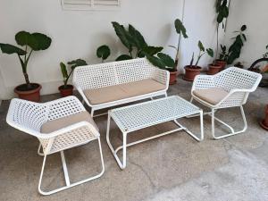 a group of four white chairs and a table at Zorica in Rafailovici