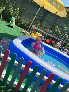 a little girl sitting in a pool in a inflatable at Casa Yva Black Sea in Venus