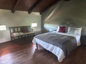 a bedroom with a large bed and a wooden floor at Casia Vacanze con due appartamenti in Bene Vagienna +12 photos