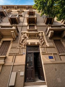 a building with a door and sculptures on it at Havana ViP in Cairo