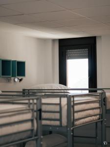 a hospital room with two beds and a window at Albergue Pundak Valle del Jerte in Cabezuela del Valle