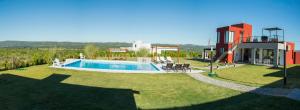 a house with a swimming pool in a yard at Colinas de Nono in Nono