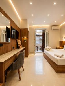 a bedroom with a bed and a desk with a television at Havana ViP in Cairo