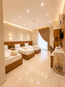 a hotel room with two beds and a table at Havana ViP in Cairo