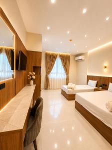 a hotel room with two beds and a desk at Havana ViP in Cairo +26 photos
