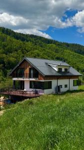 a house on a hill with a green field at Elements Chopok in Bystrá