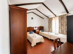 a hotel room with two beds and a window at Cortijo Domínguez - Rural Experience in Lucena +74 photos