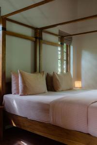 a large bed with white sheets and pillows at The Spice Trail, Ahangama in Ahangama