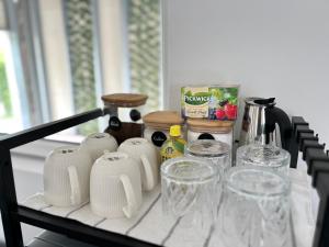 a table with glasses and other items on it at Mozaik Apartman in Kalocsa +14 photos