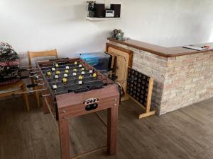 a ping pong table in front of a brick fireplace at U svaté Rozálie in Horní Věstonice