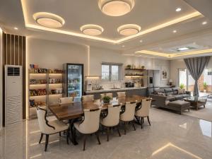 a kitchen and dining room with a table and chairs at 52stone scent poolvilla - A in Angeles