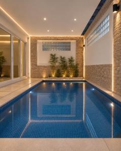 a swimming pool in the middle of a house at 52stone scent poolvilla - A in Angeles