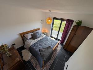 a bedroom with a bed and a window at Lon Godrum in Kingsburgh