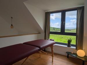 a room with a bench and a large window at Lon Godrum in Kingsburgh