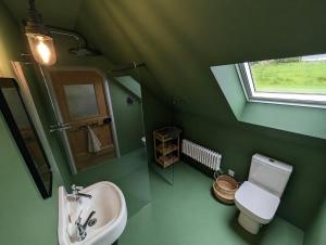 a bathroom with a sink and a toilet and a window at Lon Godrum in Kingsburgh +41 photos