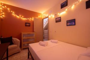 a bedroom with two beds and lights on the wall at The Garden House in Siviri