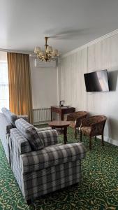 a living room with a couch and a table at Белес in Astana