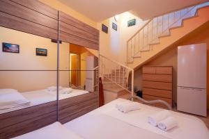a room with two beds and a staircase at The Garden House in Siviri