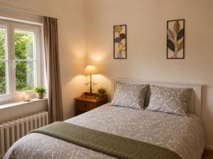 a bedroom with a bed and a window at Secret Garden in Waterloo