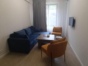 a living room with a blue couch and a table at Apartment in Verin Apart hotel in Dilijan in Dilijan