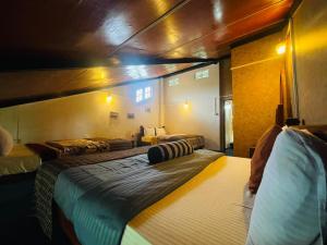 a bedroom with two beds in a room at Himawari Hills Hostels in Nuwara Eliya +17 photos