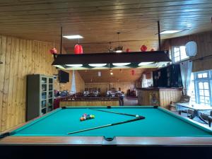 a pool table in the middle of a room at Himawari Hills Hostels in Nuwara Eliya