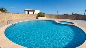 a large blue swimming pool in a backyard at Apartment with pool in Cala Millor in Cala Millor
