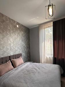 a bedroom with a large bed and a window at Golden Horizon in Ts'ikhisdziri