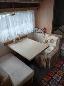 a small room with a table and a bed with stuffed animals at Pod Wierzba in Dobrzyki