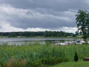 a lake with a bunch of boats in the water at Pod Wierzba in Dobrzyki +4 photos