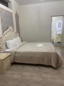 a bedroom with a large bed and a table at RUBENYAN GUEST HOUSE in Artashat