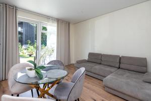 a living room with a couch and a table and chairs at 4rest in Palanga