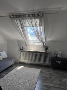 a living room with a couch and a window at Ferienwohnung Alpenglück mit Schwimmbad und Sauna in Oberstdorf +35 photos