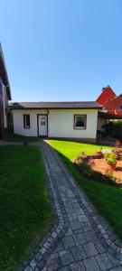 a house with a driveway in front of a yard at Ferienhaus Margarete in Dankerode