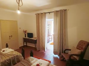 a living room with a couch and a room with a piano at Casa do Coreto in Crato