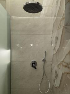 a shower with a shower head in a bathroom at Ayla Shalet Villa in Al Kufayr